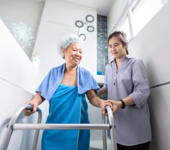 caregiver wrapping elderly man's arm
