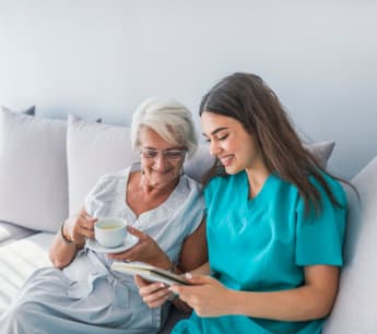 caregiver assisting elderly woman