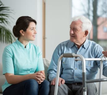 caregiver assisting elderly woman in the road